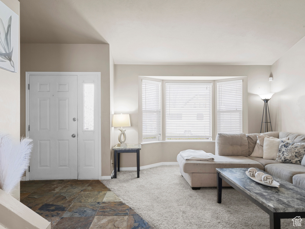 Living area featuring baseboards and stone finish flooring