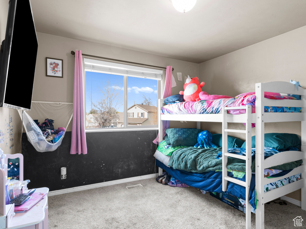 Carpeted bedroom with baseboards