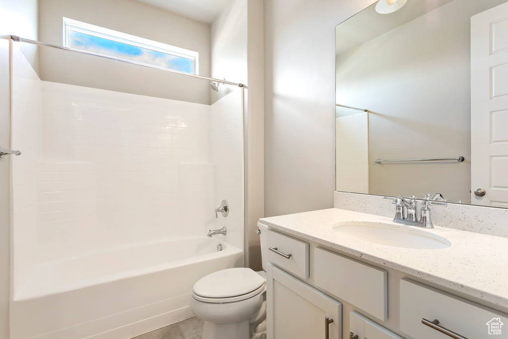 Bathroom with toilet, vanity, and shower / tub combination