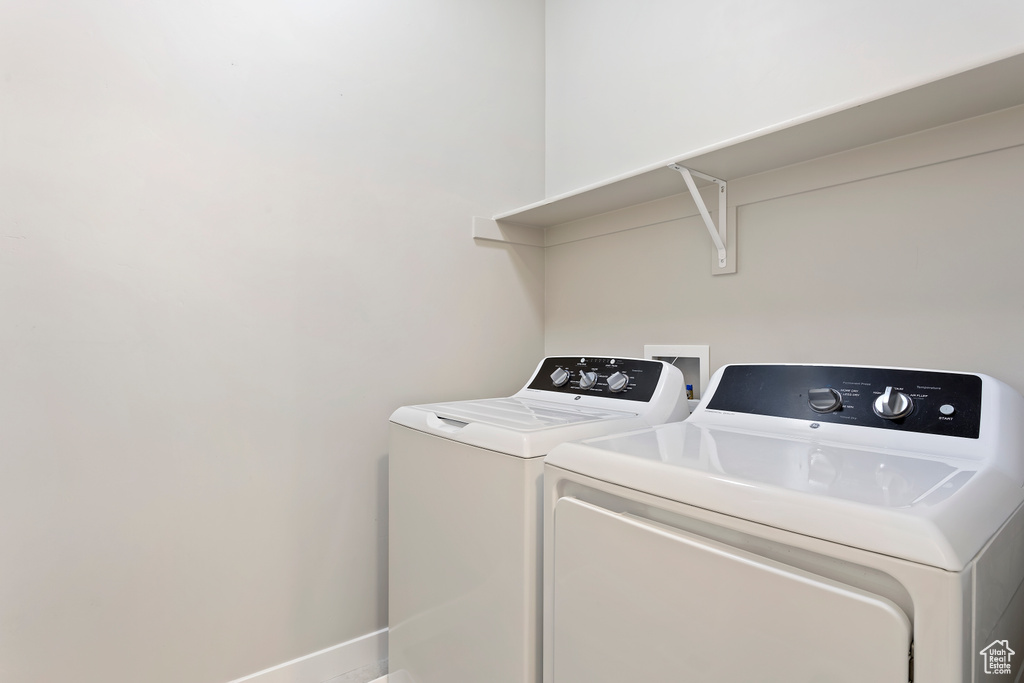 Laundry room with washer and clothes dryer and laundry area