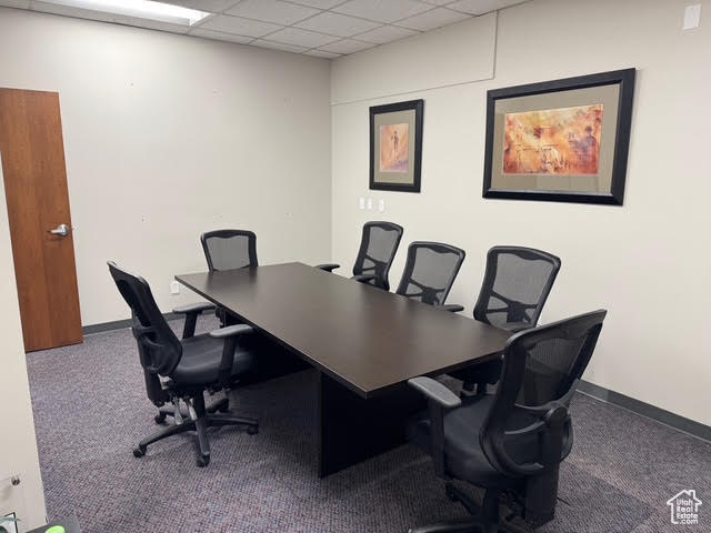 Office space featuring carpet floors, baseboards, and a drop ceiling