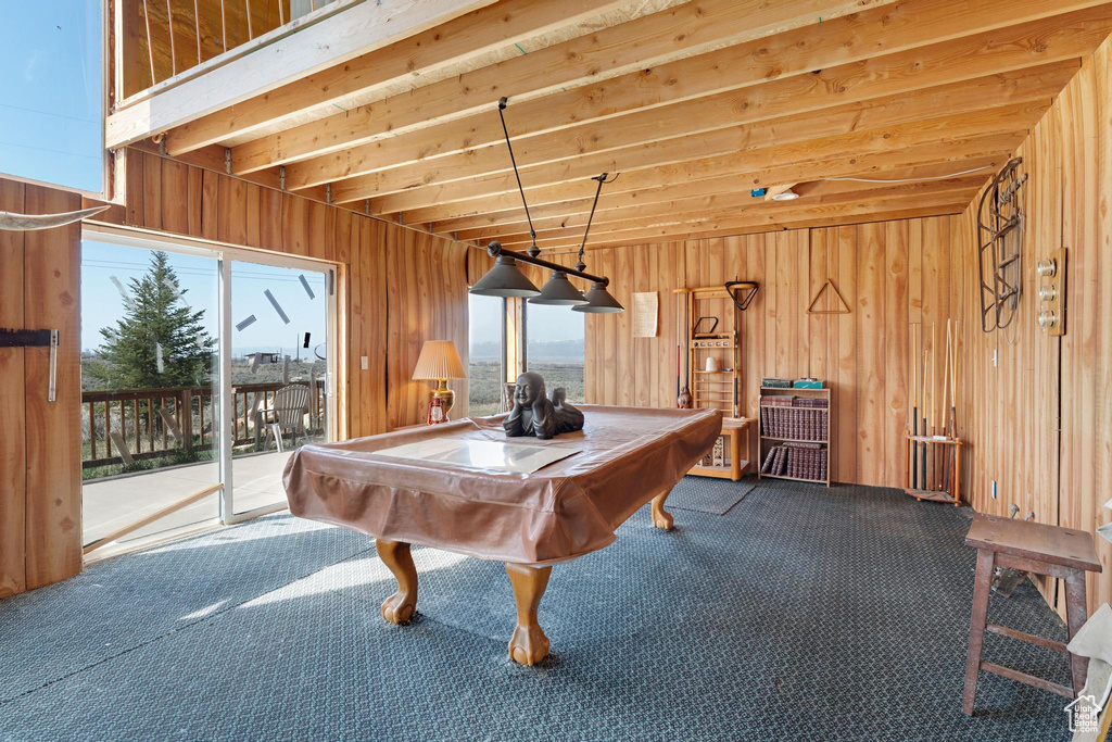 Recreation room featuring dark carpet, wooden walls, pool table, and a wealth of natural light