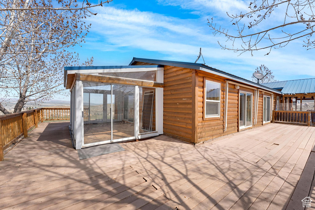 Deck featuring a sunroom