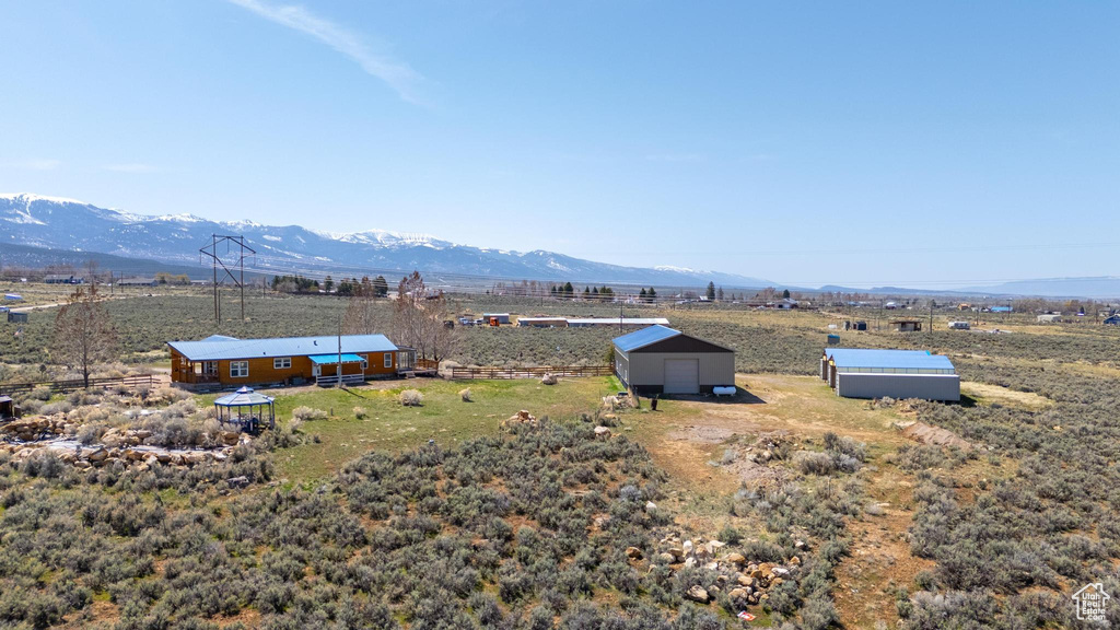 Exterior space with a rural view, a mountain view, and an outbuilding