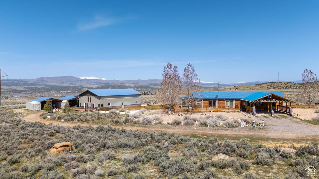 Back of property featuring an outdoor structure and a mountain view