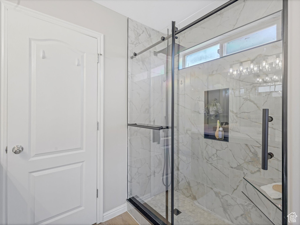 Full bathroom with a marble finish shower