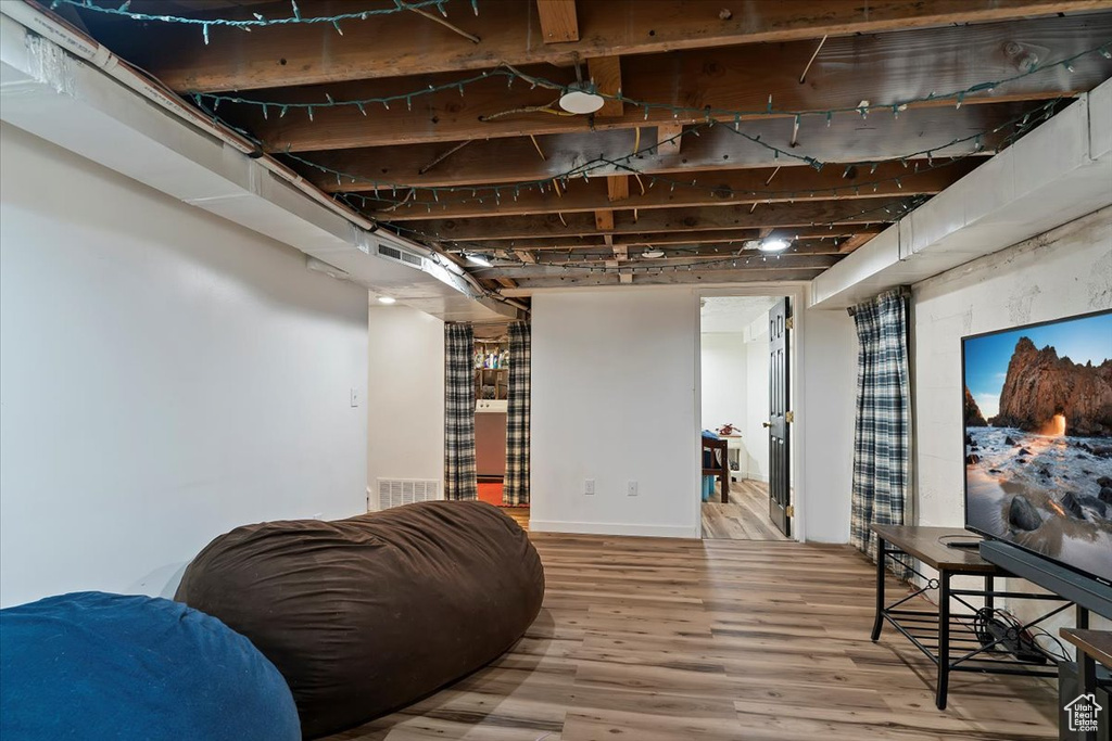 Below grade area featuring visible vents and wood finished floors