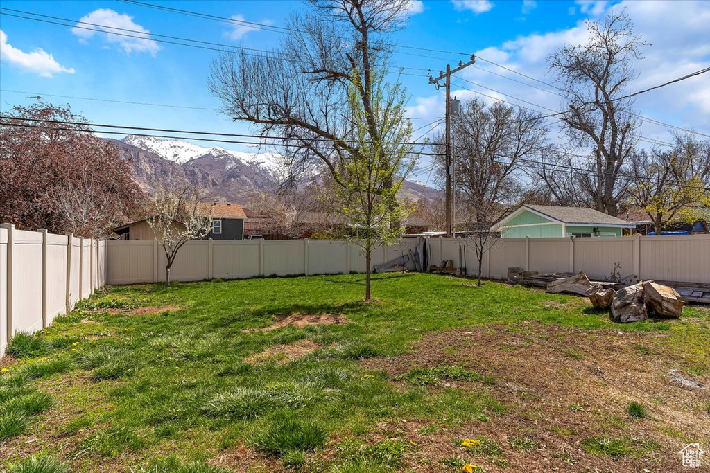 View of yard featuring a mountain view and a fenced backyard