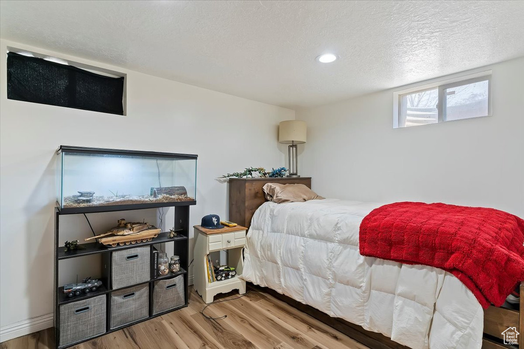 Bedroom featuring recessed lighting, a textured ceiling, and wood finished floors