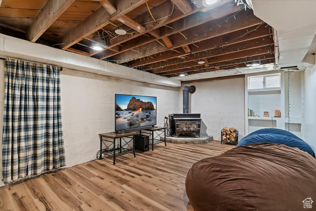 Living room featuring a wood stove and wood finished floors