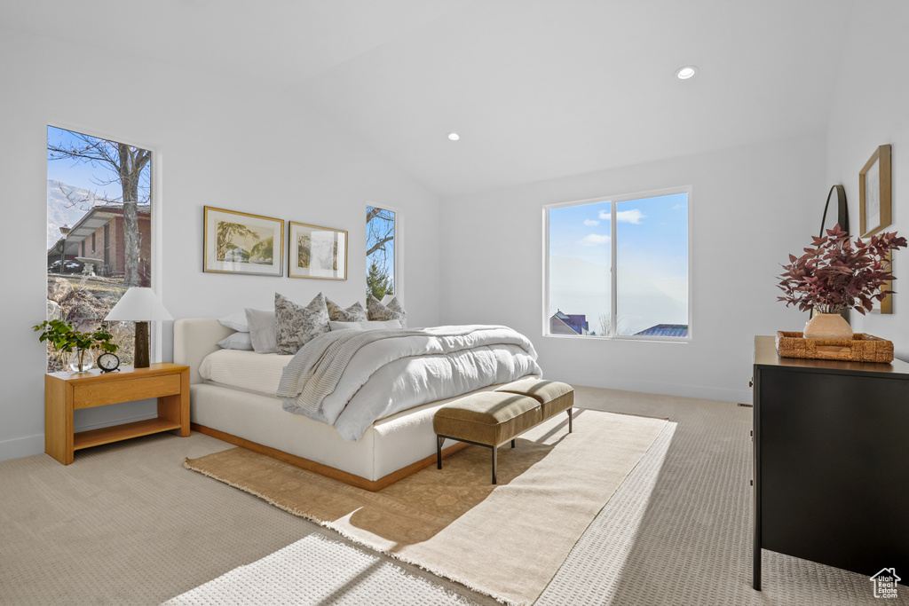 Bedroom featuring baseboards, recessed lighting, light carpet, and lofted ceiling