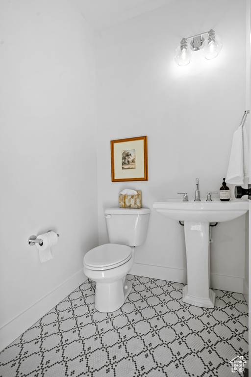 Bathroom featuring toilet and baseboards