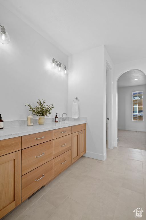 Bathroom featuring vanity and baseboards