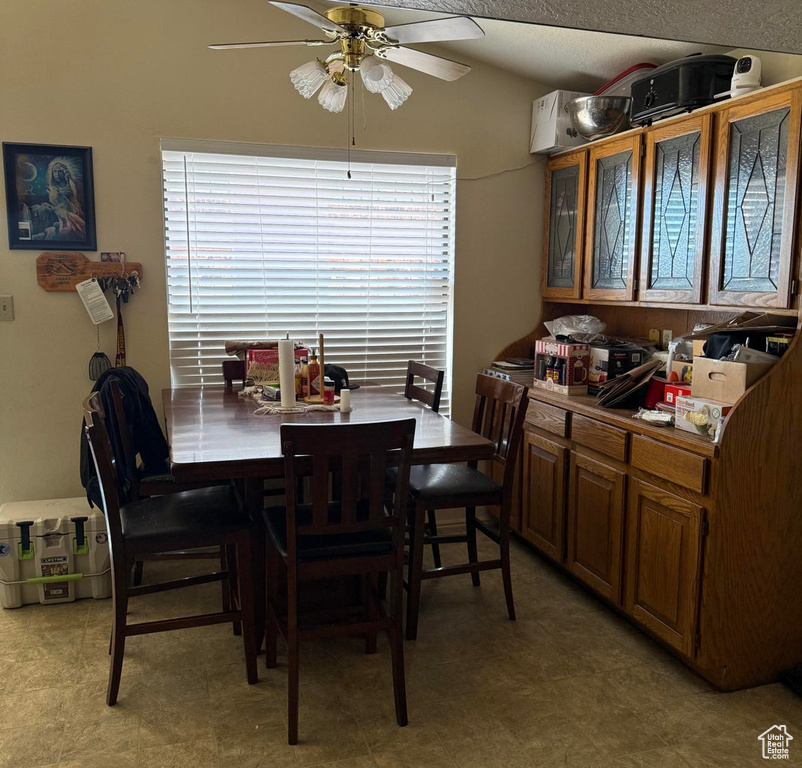 Dining area with ceiling fan and lofted ceiling