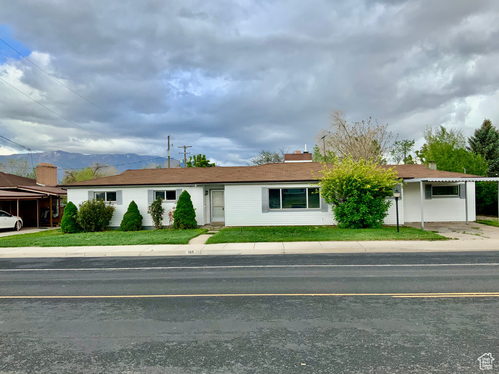 Single story home featuring a front lawn