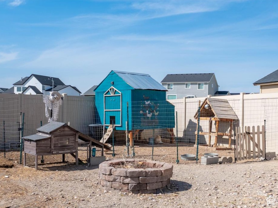View of yard featuring a fenced backyard, an outdoor structure, and exterior structure