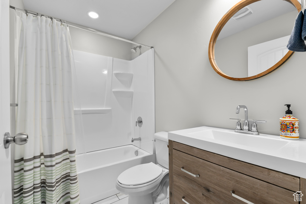 Full bathroom with shower / tub combo, vanity, recessed lighting, toilet, and visible vents