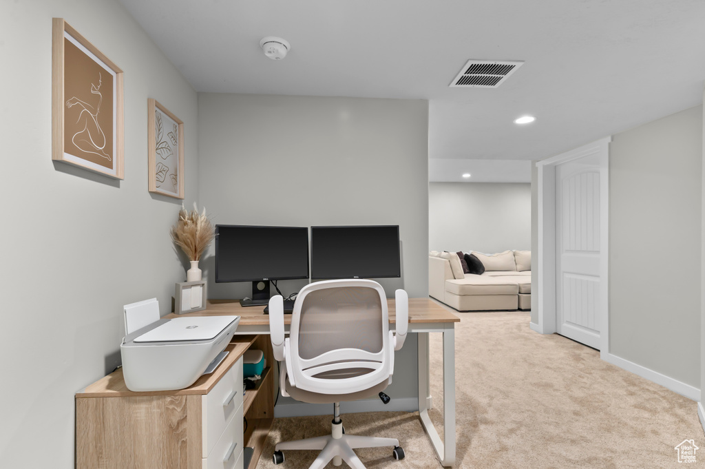 Carpeted office space featuring visible vents, baseboards, and recessed lighting