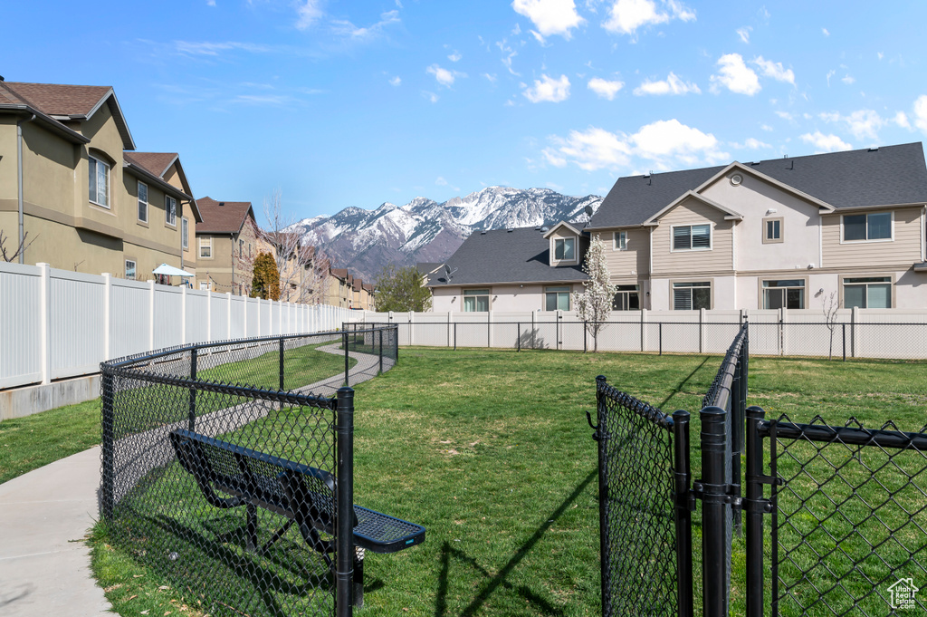 View of yard with a residential view, a mountain view, and fence