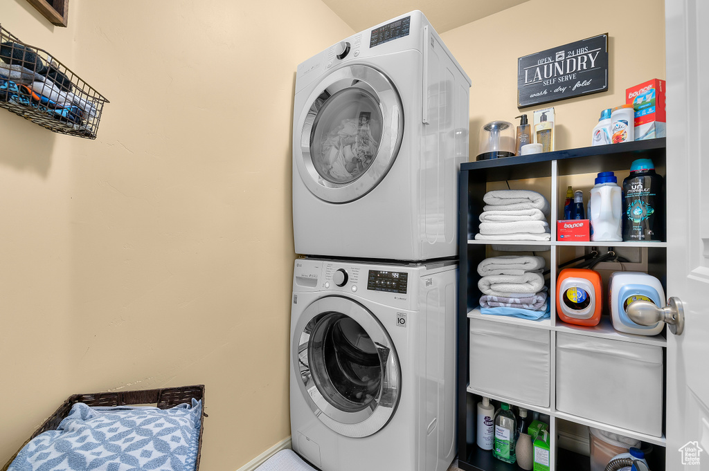 Laundry room with stacked washing maching and dryer and laundry area