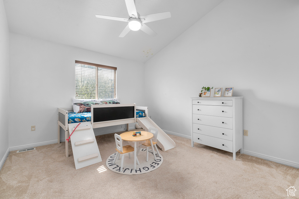 Carpeted office with high vaulted ceiling, baseboards, a ceiling fan, and visible vents