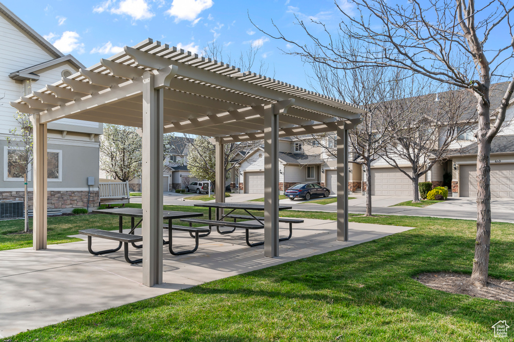 View of community featuring a residential view, a lawn, and a pergola
