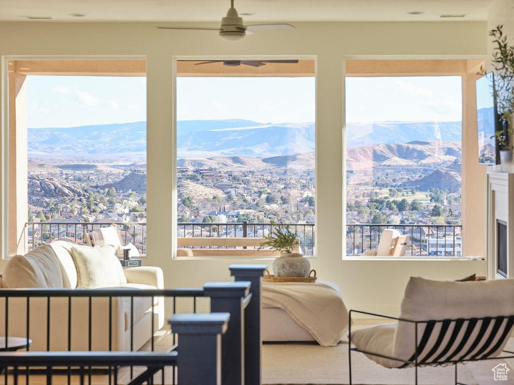 Interior space featuring a mountain view, ceiling fan, and a wealth of natural light