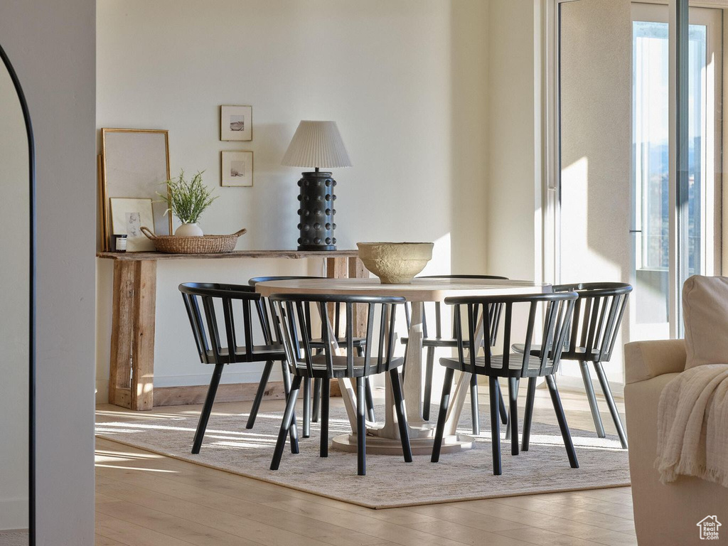 Dining space featuring plenty of natural light and wood finished floors
