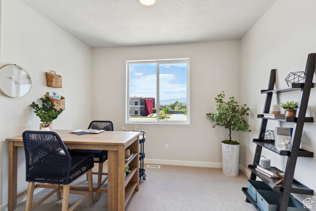 Carpeted office featuring baseboards