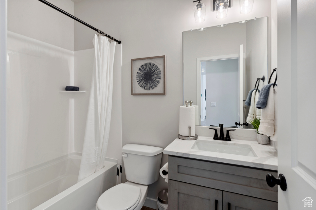Full bath featuring vanity and shower / bath combination with curtain