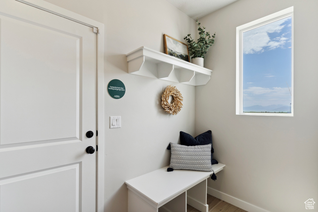 Mudroom featuring wood finished floors and baseboards