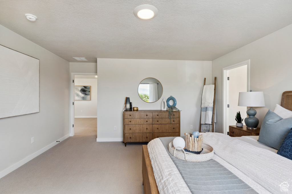 Bedroom with light carpet and baseboards