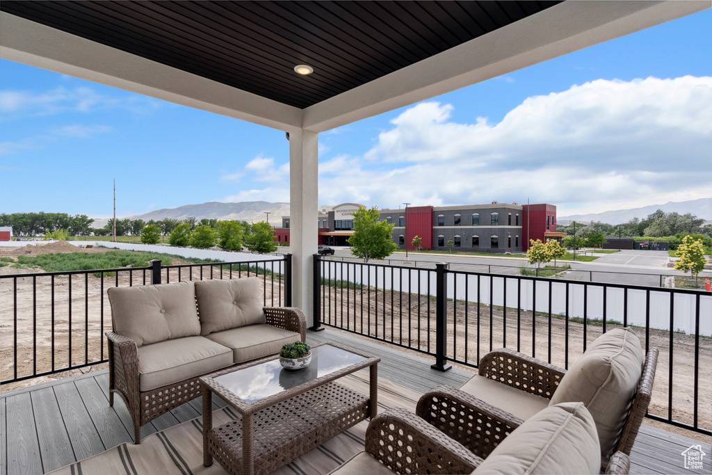 Wooden deck featuring a mountain view and an outdoor living space