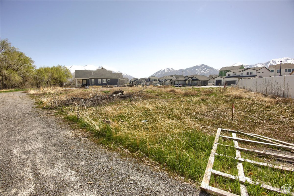 View of yard with a mountain view, fence, and a residential view