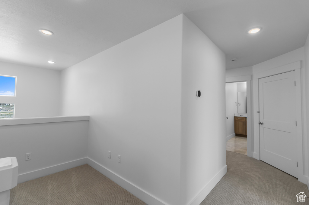 Hall with recessed lighting, carpet floors, and baseboards