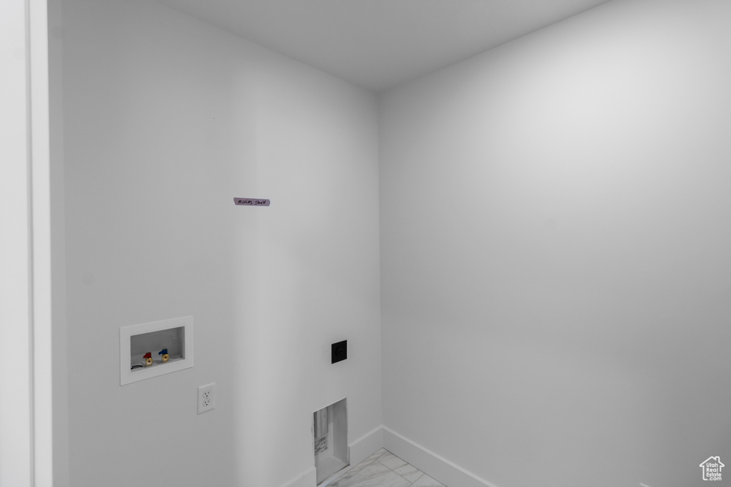 Laundry room with baseboards, washer hookup, laundry area, and marble finish floor