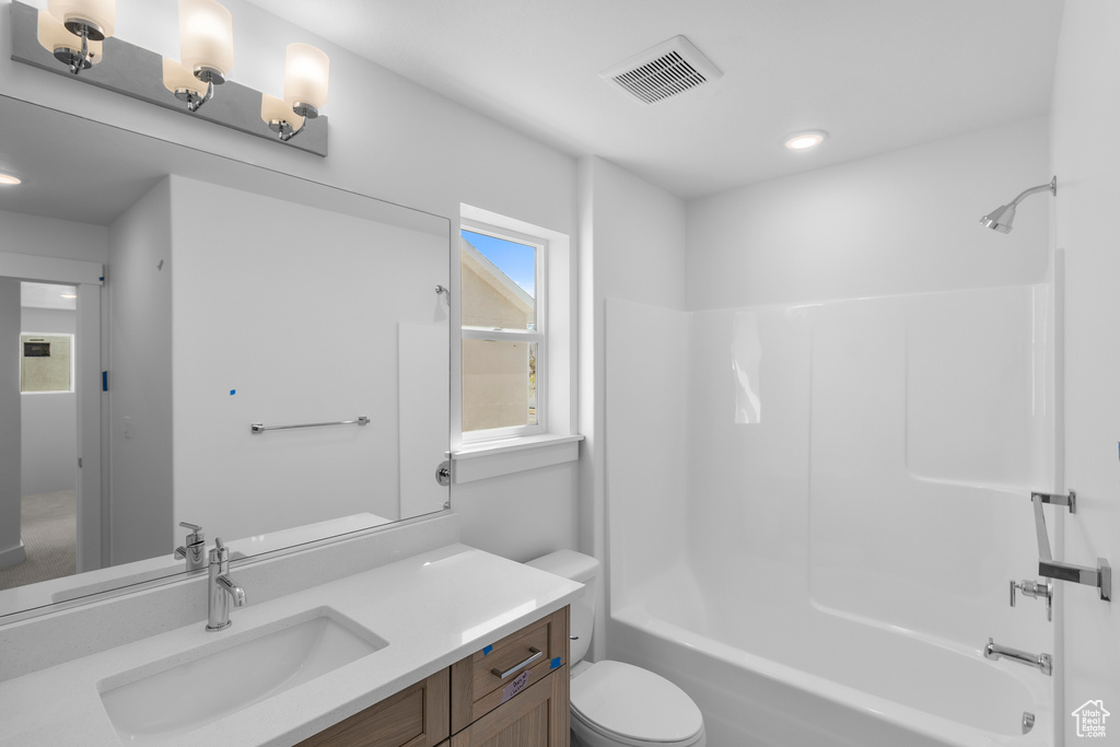 Full bathroom featuring washtub / shower combination, visible vents, toilet, recessed lighting, and vanity