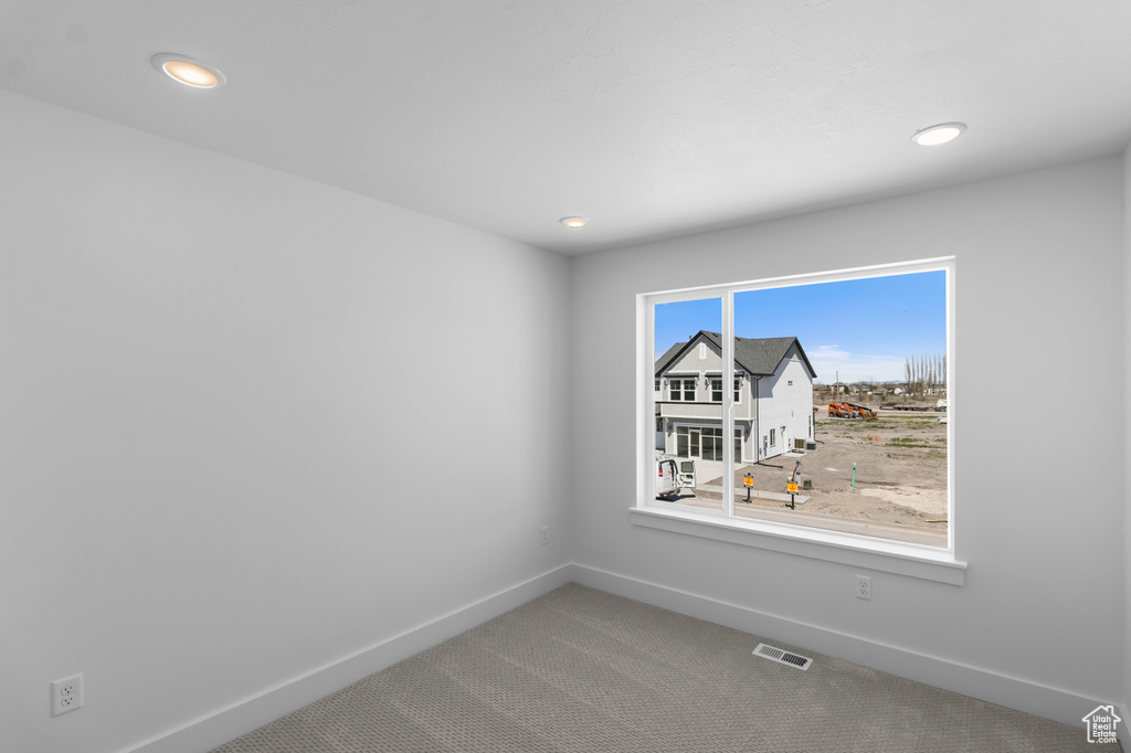Spare room with visible vents, recessed lighting, carpet flooring, and baseboards
