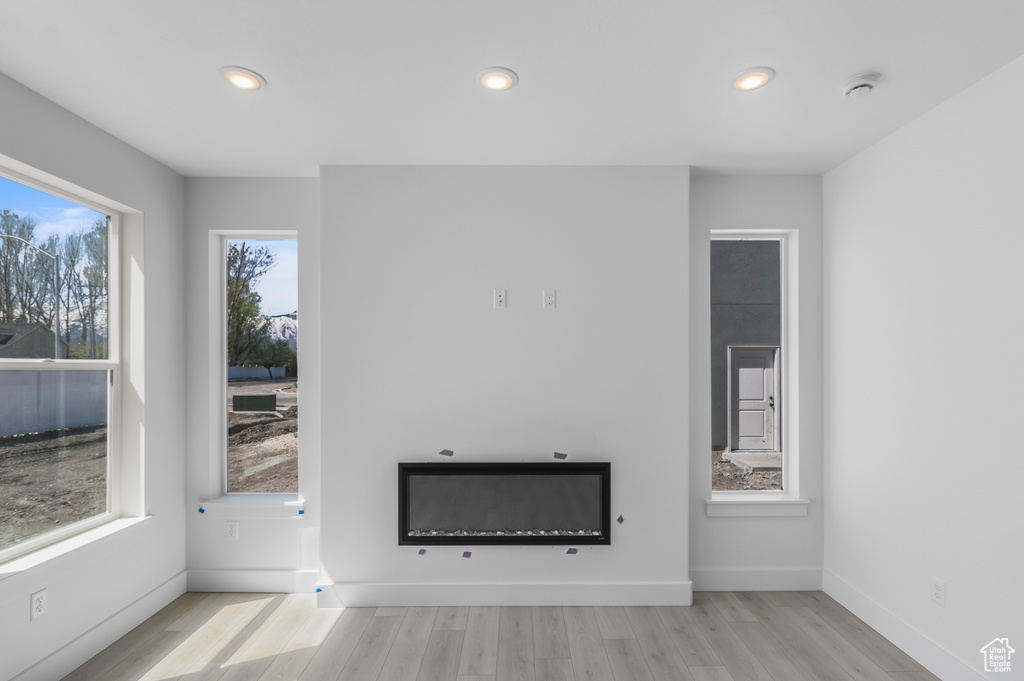 Unfurnished living room featuring recessed lighting and wood finished floors