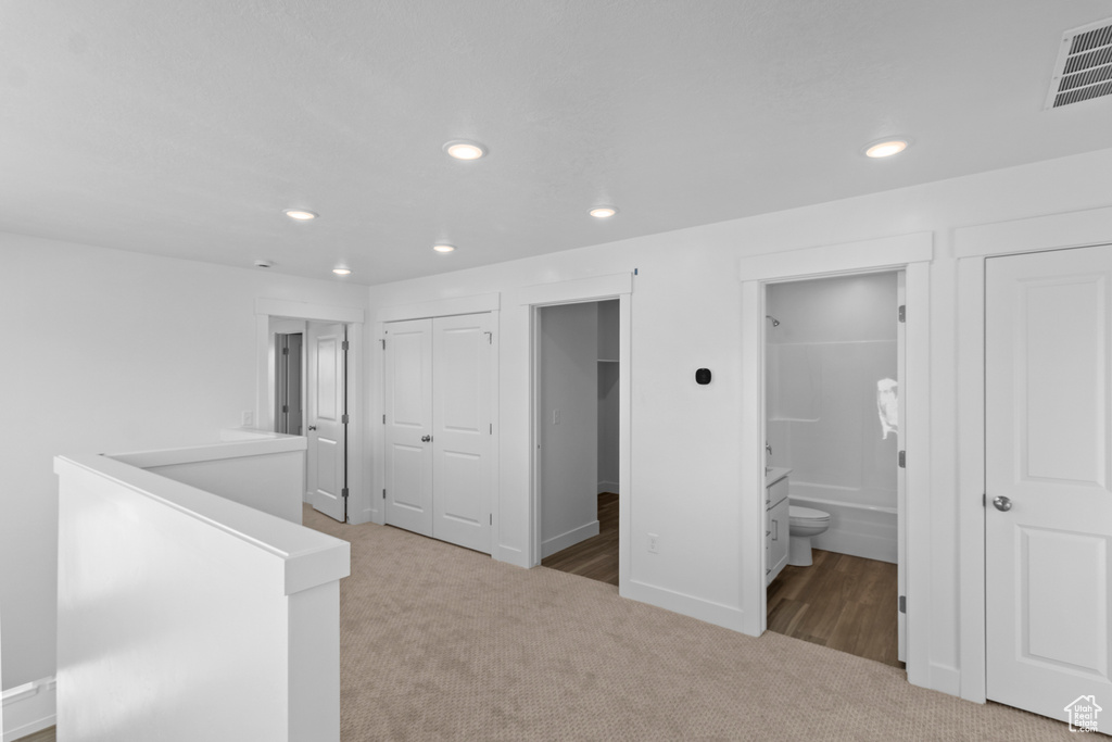 Hallway with recessed lighting, carpet flooring, an upstairs landing, visible vents, and baseboards