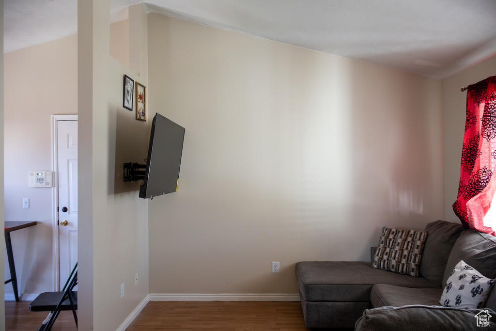 Living area featuring baseboards and wood finished floors