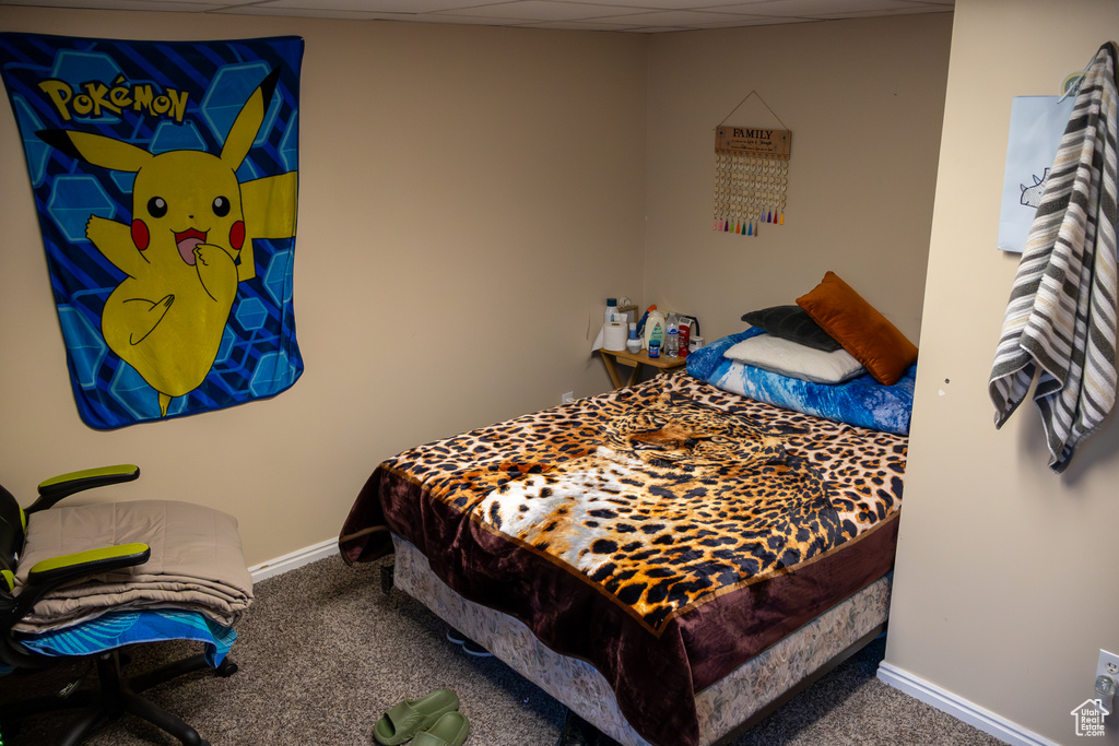 Bedroom featuring carpet floors and baseboards