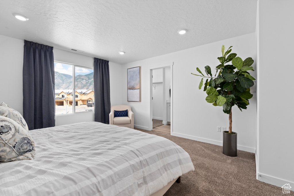 Bedroom featuring a mountain view, baseboards, recessed lighting, and carpet floors