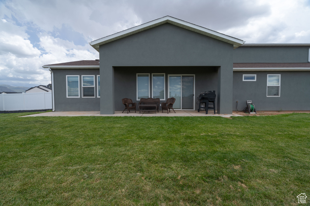 Back of property with stucco siding and a patio area