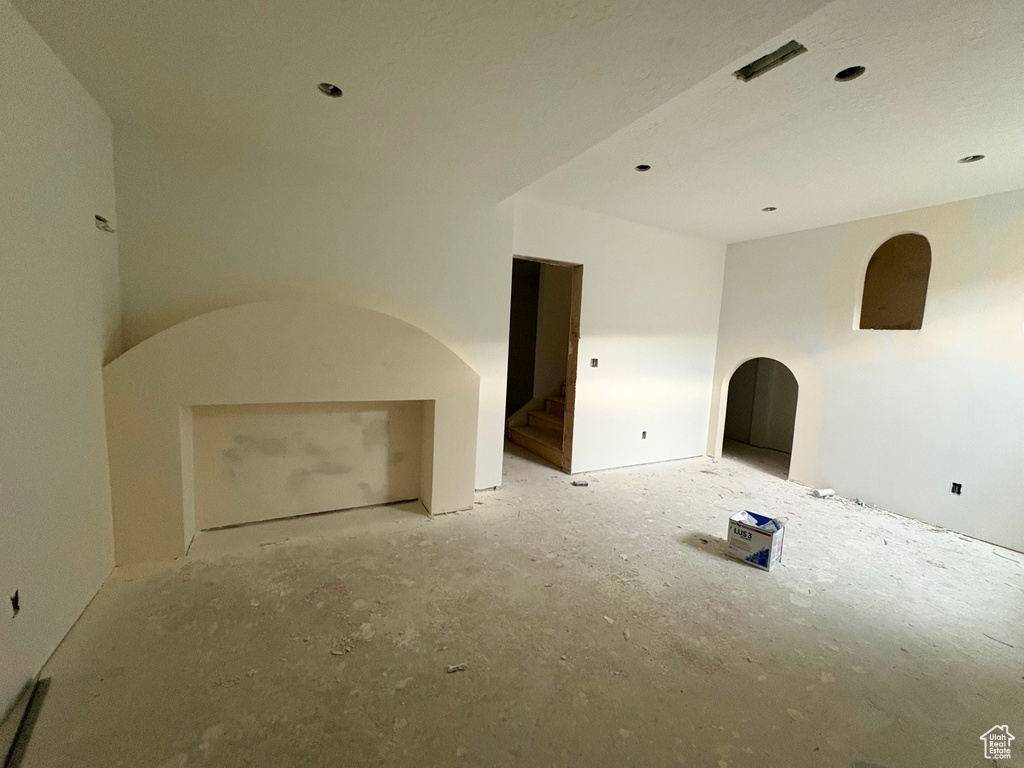 Unfurnished living room with arched walkways