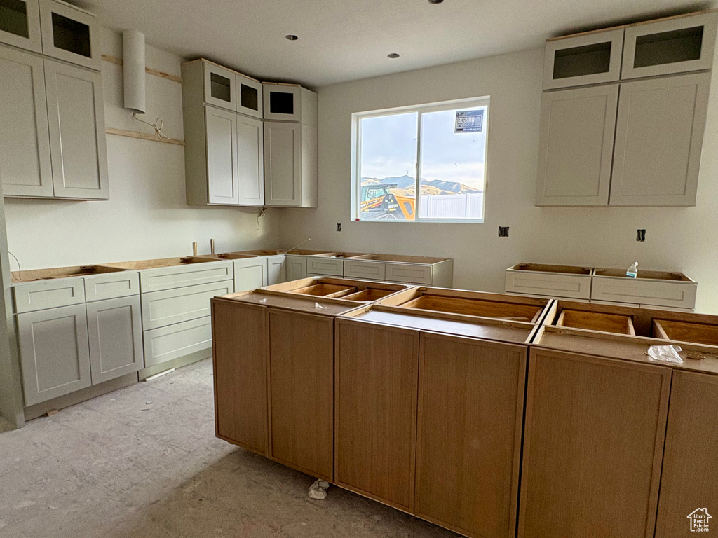 Kitchen with glass insert cabinets and a sink