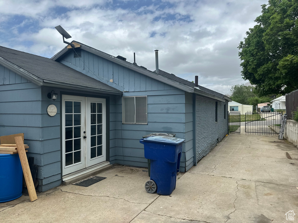 Rear view of property featuring french doors and fence