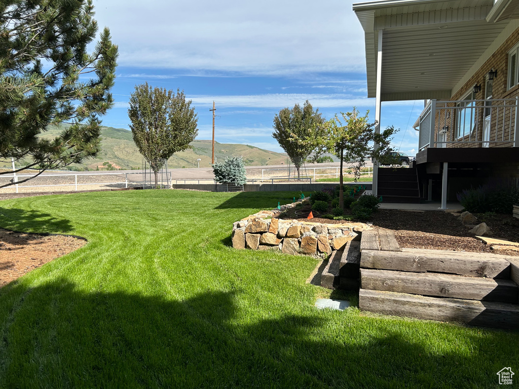 View of yard with stairway and a mountain view