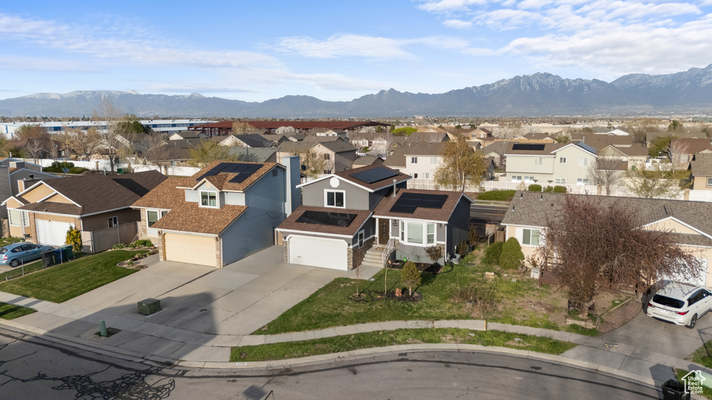 Birds eye view of property with a mountain view and a residential view