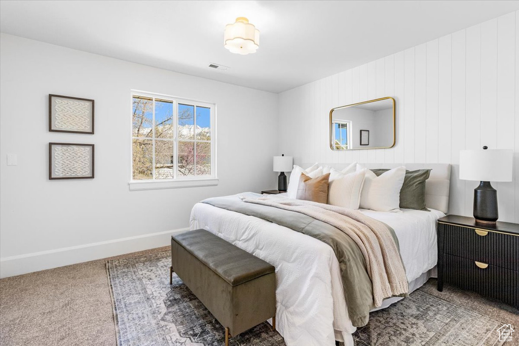 Carpeted bedroom featuring visible vents and baseboards